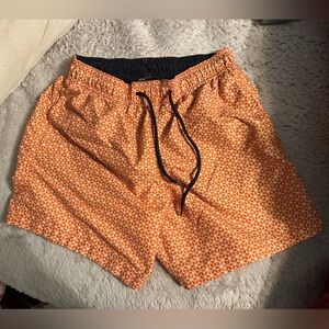 H&M men’s swim trunks. Orange and white geometric pattern. Size XS
